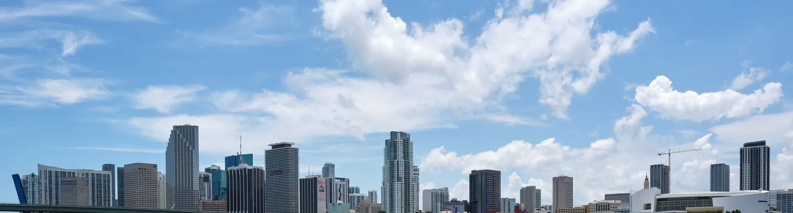 The Miami skyline across Biscayne Bay, with high-rise towers along the waterfront.