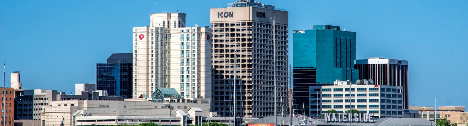 Downtown Norfolk, Virginia in daylight, with waterfront buildings along the Elizabeth River.